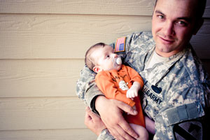 Military father holding his baby.