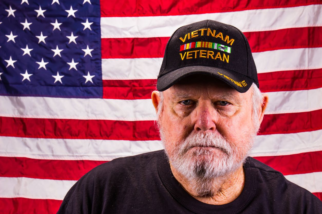Vietnam Vet Looking At Camera With American Flag Background